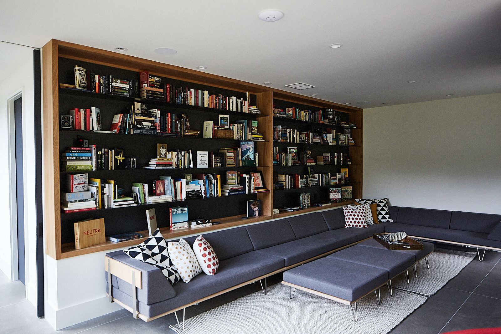 evergreen-portfolio-danish-modern-shingle-home-interior-LR-living-room-bookshelf-couch
