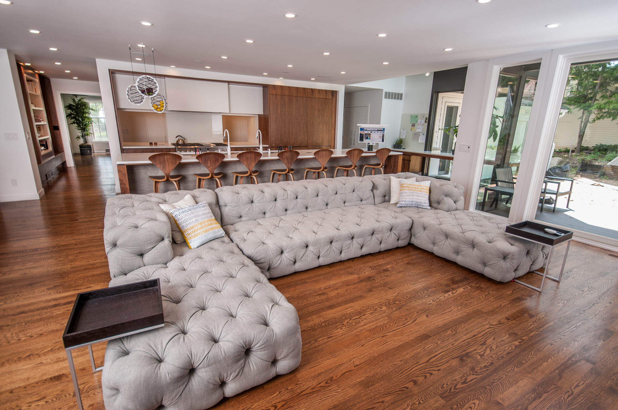 evergreen-portfolio-kensington-modern-revival-interior-LR-living-room-wide-couch-kitchen-barstools